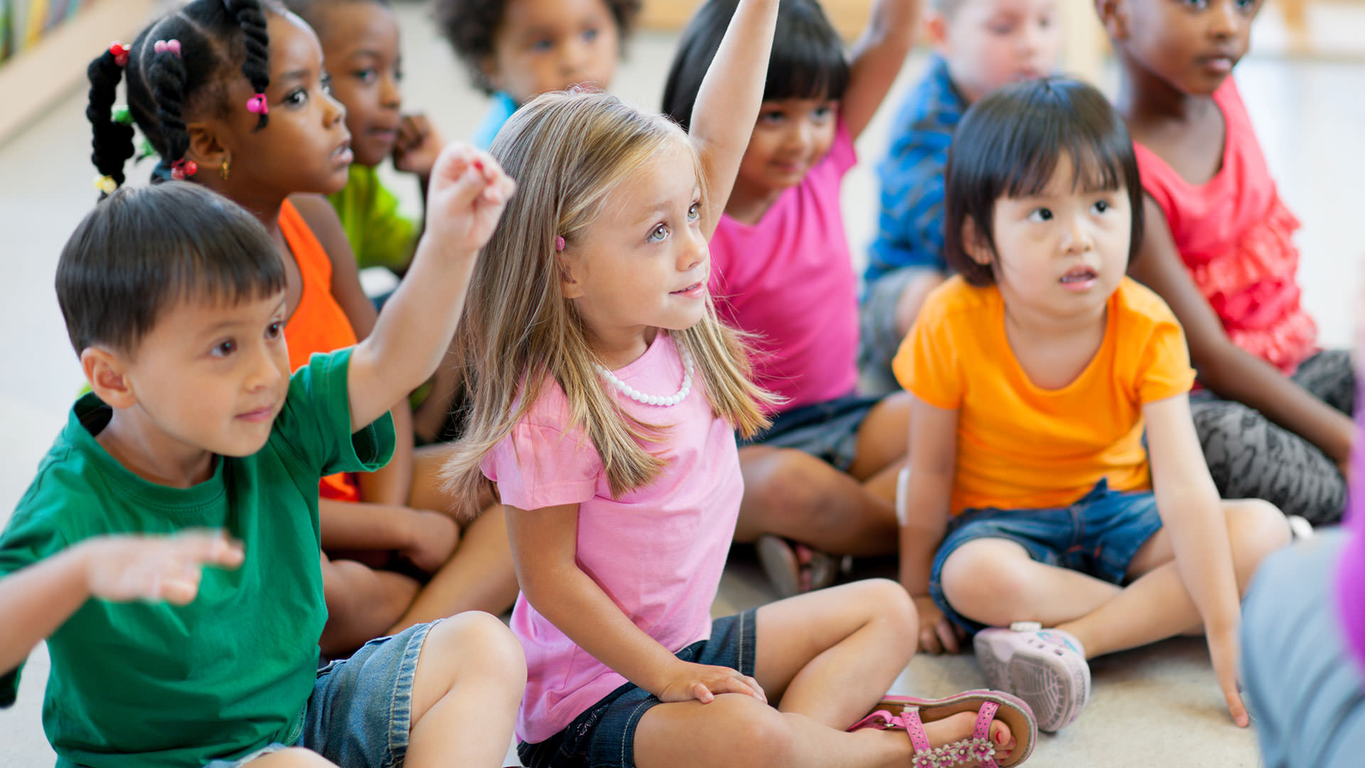 Student with raised hand in classroom