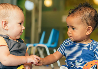 Infants holding hands