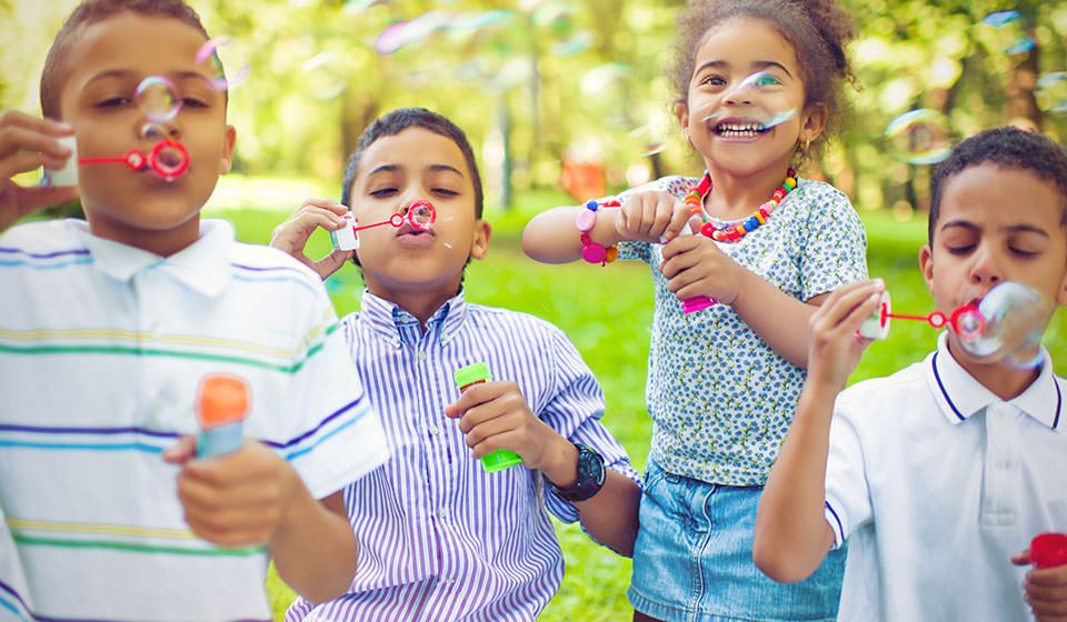 Summer camp kids blowing bubbles